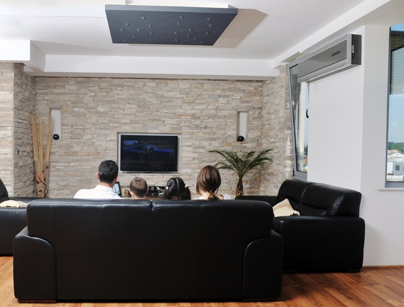 happy young family wathching flat tv at modern home indoor-1